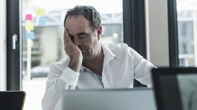 man-exhausted-employee-white-shirt