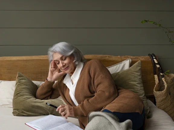 older-woman-reading-while-using-magnifying-glass