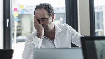 man-exhausted-employee-white-shirt