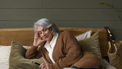 older-woman-reading-while-using-magnifying-glass